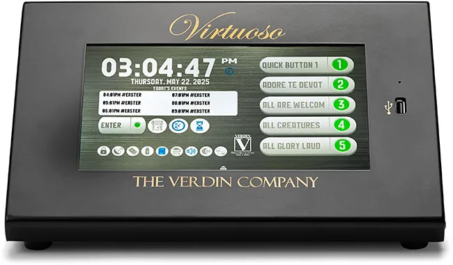Virtuoso Carillon, a compact black device with a touch display. The screen prominently shows the current date, time, and system status, along with five customizable preset buttons and other options.
